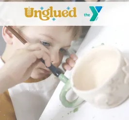 photo of child painting mug